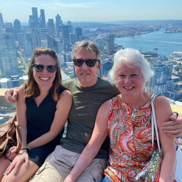 Group of three sitting on a sunny day on the Skyriser glass benches